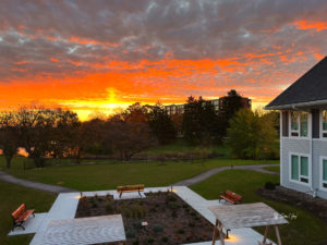 A brilliant orange sunrise fills the sky above Kathy's House