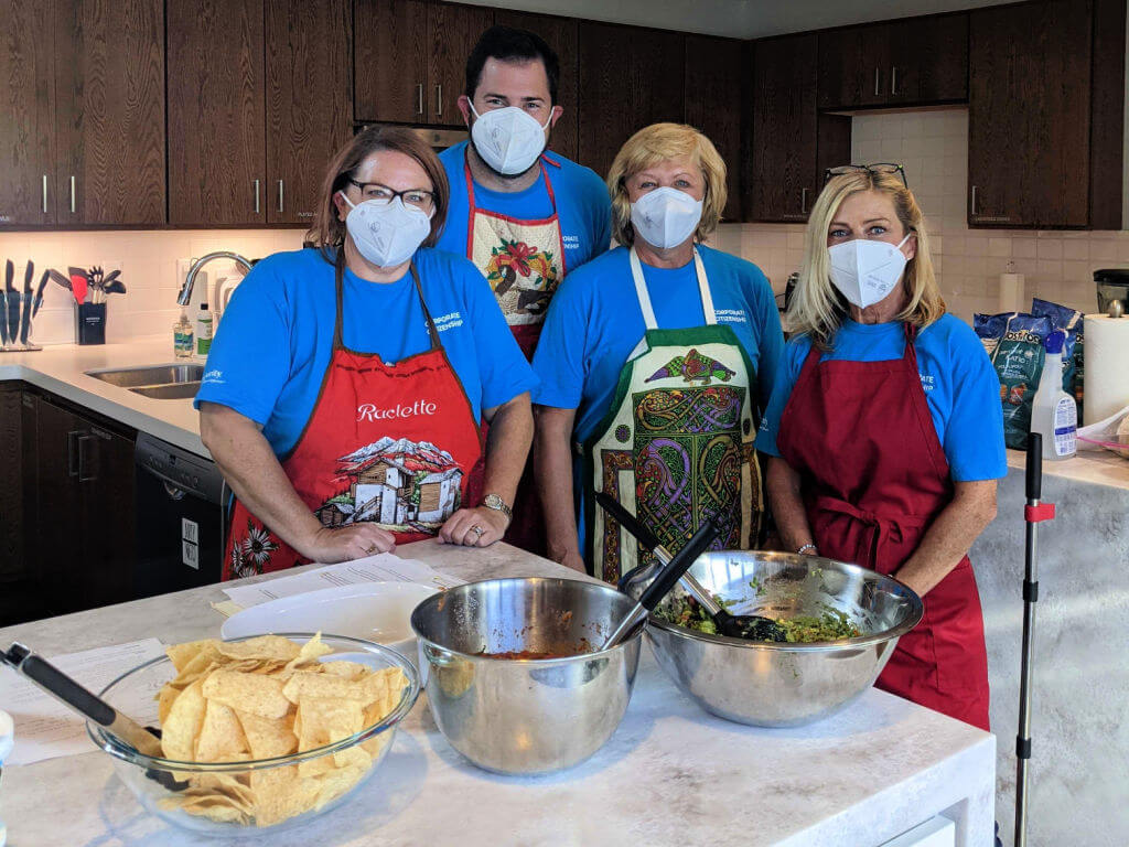 Four volunteers from Insperity pose in the Kathy's House kitchen.